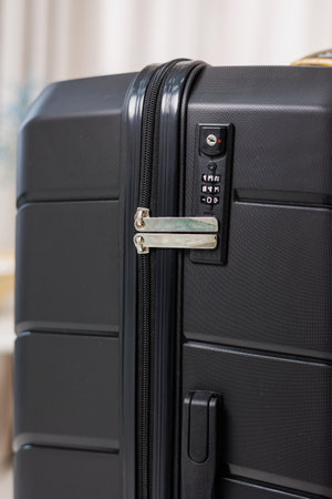 Black beautiful suitcase for tourist trips. High-quality black suitcase