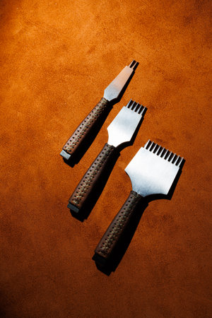 Tools for making leather goods and pieces of brown leather. Production of leather products. View...