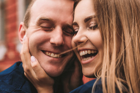 Happy couple hugging and smiling. Portrait of a guy and a girl with a smile on their faces.の写真素材