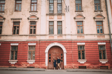 Happy beautiful young couple on the background of red old doors. Happy family conceptの写真素材