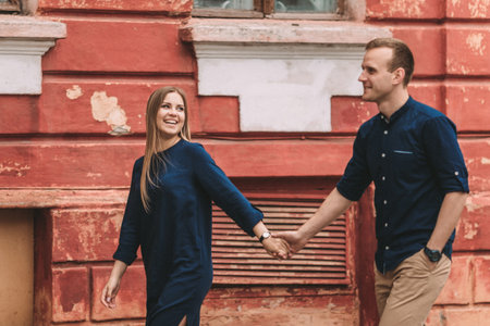 Happy couple in love walks the city streets together. A lovely couple on the old narrow streets of...