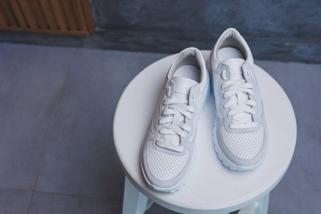 White women's leather sneakers close-up. New collection of women's summer leather shoes.の写真素材