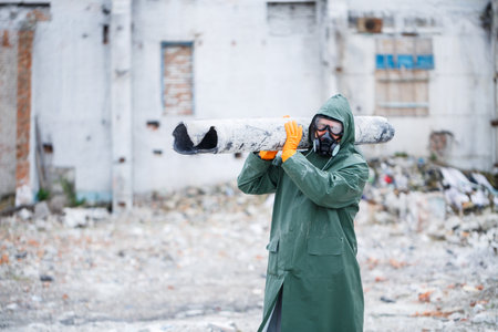 A man in a protective mask and protective clothing explores the danger zone. Ecological catastrophe. selective focusの写真素材