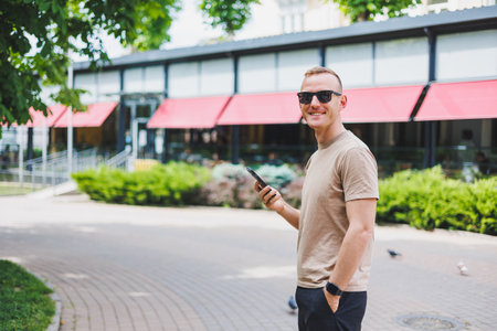 Man in shopping. Smiling man with shopping bags walking down the street. Consumerism, lifestyle conceptの写真素材