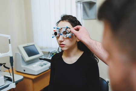 Eye examination of a young woman at an ophthalmologist's appointment using modern microscopes. Vision treatment at an ophthalmologist appointmentの写真素材