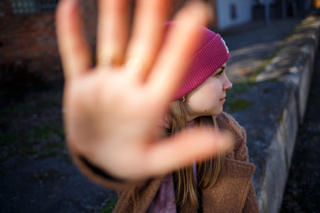 stylish girl model in a brown coat, pink suit and gray boots on the city ruins. The trends of modern fashion. Fashionable imageの写真素材