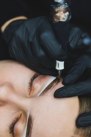 Young woman during professional eyebrow mapping procedure before permanent makeupの写真素材