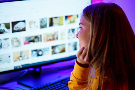 girl freelancer looks on the computer screen news about forest fires and the virus COVID-19の写真素材