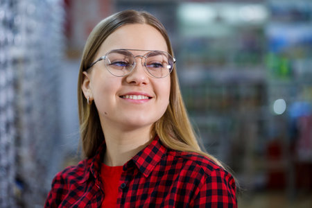 The girl in the shirt takes out and measures on herself glasses