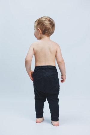 Fan boy holding a soccer ball in his hands, isolated on a white background. newbie in football, sport for kids. Little athlete.の写真素材