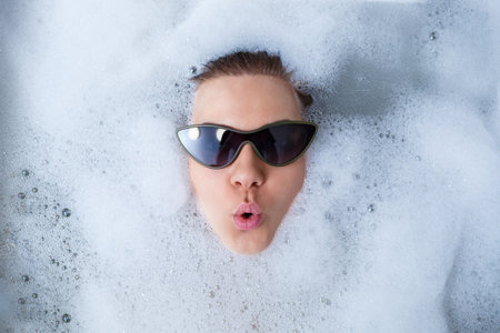 Young woman with sunglasses getting spa treatment in a beauty salon, inside an interior room. Relax...