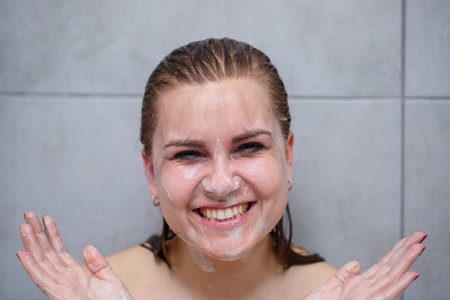Face skin care. Woman applying facial cleanser on face closeup. Girl using cleansing cosmetic...