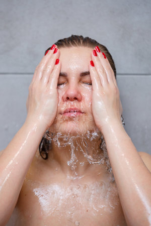 Facial skin care. Woman applying water by hands on face closeup. Girl washes her face with water,...