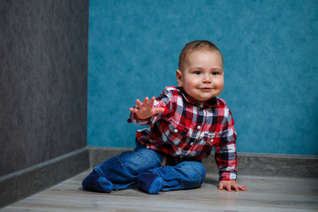 little boy ten months old in a shirt and jeansの写真素材