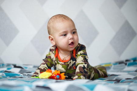 portrait of a little boy age 8 months and is smiling. Health and development of children