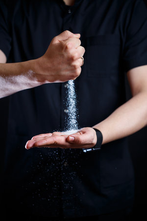 An adult man of European appearance wearing a black medical suitの写真素材