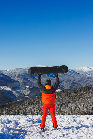 Winter sport. A snowboarder walks down a snowy slope in winter on the snow. Snowboarding, winter freerideの写真素材