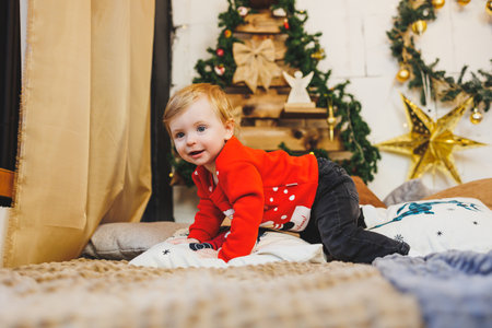 little one-year-old boy near the Christmas tree. an idea for a children's photo for the new year....