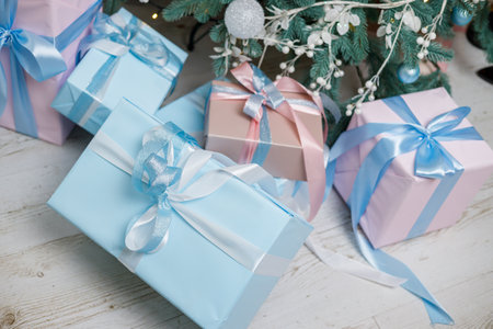 The Christmas tree is decorated with toys and garlands with gifts under it. Christmas gifts under...
