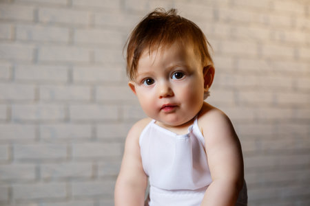 Little boy in a cap and with bread. Little child dressed as a cook in the kitchen.の写真素材