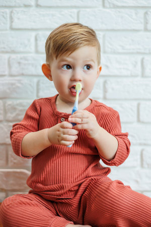 A small child learns to brush his teeth with a toothbrush. Dental hygiene in childrenの写真素材