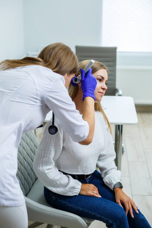 A young woman at the reception of a female doctor-specialist. Therapist conducts a preventive...