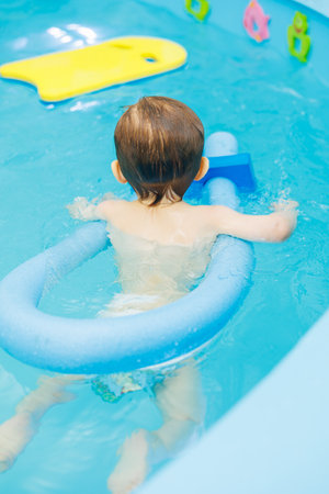Little boy 2 years old are in the pool. Swimming lessons for young children.の写真素材