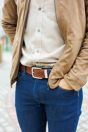 Men's brown leather belt for trousers. Brown belt on men's trousers