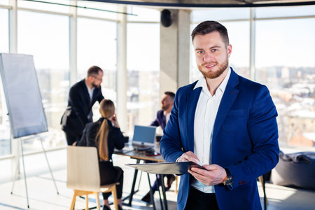 Successful handsome male mentor, director, businessman in a suit at the office. Working day concept....