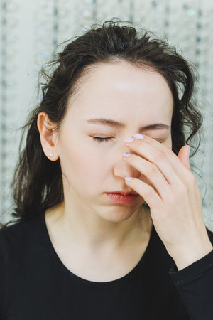 Close-up of a woman's face with dilated pupils after ophthalmic treatment.