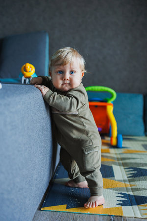 baby first steps. happy family kid dream concept. father teaches baby daughter to take first steps at lifestyle home in front of window. father's day concept. baby takes his first stepsの写真素材