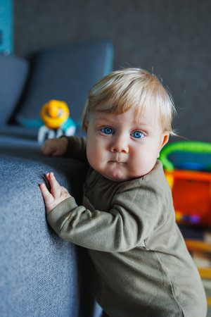 baby first steps. happy family kid dream concept. father teaches baby daughter to take first steps at lifestyle home in front of window. father's day concept. baby takes his first stepsの写真素材