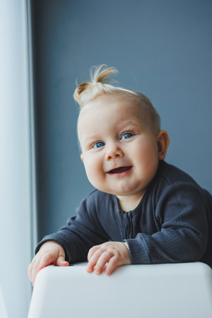 Cute little boy in a bodysuit with a smile on his face. The child looks at the camera, smiles. Clothes for babiesの写真素材