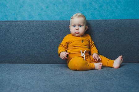Cute little boy in a yellow suit. Clothes for babies.の写真素材