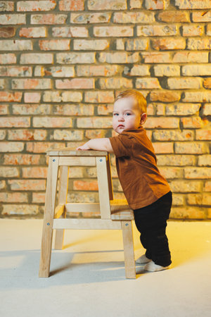 Baby in cool casual clothes. Little stylish boy, child 1 year old in jeans and t-shirt. Stylish clothes for babies.の写真素材