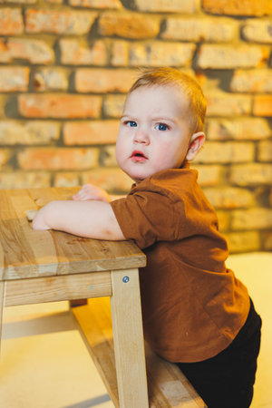 Baby in cool casual clothes. Little stylish boy, child 1 year old in jeans and t-shirt. Stylish clothes for babies.の写真素材