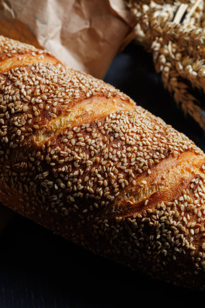 Fresh delicious wheat bread sprinkled with sesame seeds. Homemade baking. Craft breadの写真素材