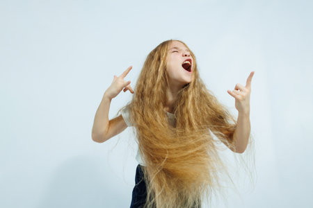 Laughing girl in white t-shirt and jeans portrait isolated on white background. The concept of children's emotions, childhood.の写真素材