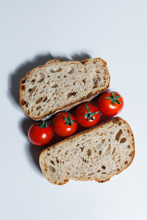 Craft bread with cherry tomatoes. Homemade baking. Unleavened rye bread.の写真素材