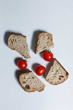 Craft bread with cherry tomatoes. Homemade baking. Unleavened rye bread.
