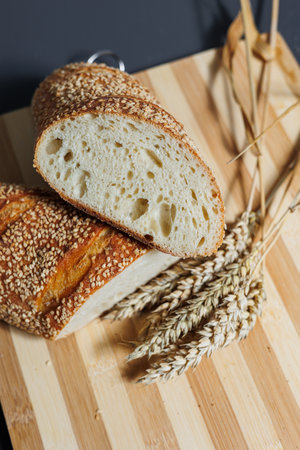 Freshly baked rye bread on yeast-free sourdough and whole grain, rye and wheat flour. It lies on a cut board.の写真素材