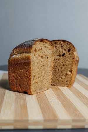 Freshly baked rye bread on yeast-free sourdough and whole grain, rye and wheat flour. It lies on a...
