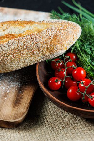 Craft bread with cherry tomatoes. Homemade baking. Unleavened rye bread.の写真素材