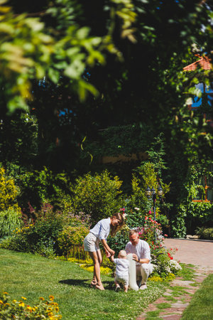 Mom and dad in nature with their one-year-old son. Happy family with little son in nature.の写真素材