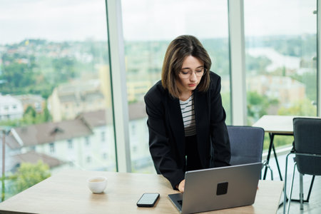 Young woman working in a spacious office. Successful people are working on a new business project. Collective work in the officeの写真素材