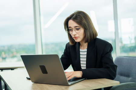 Young woman working in a spacious office. Successful people are working on a new business project. Collective work in the officeの写真素材