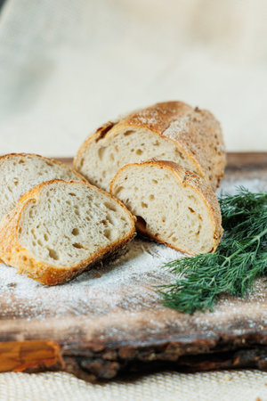 Homemade bread, bread with wheat and spelled flour. Texture of bread sliced and cut in half on a...