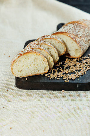Delicious fresh bread cut into slices. Fresh craft pastries.
