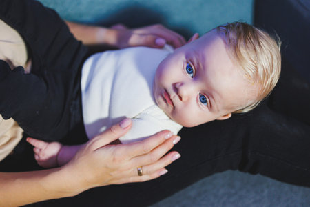 Portrait of a blue-eyed baby. A little boy is looking at the camera.の写真素材