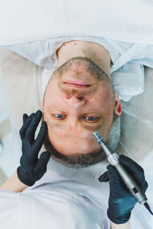 Male cosmetology in a beauty salon. A man takes care of his facial skin.の写真素材